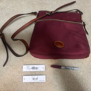 GUC Dooney & Bourke cranberry cloth crossbody swingpack with leather accents